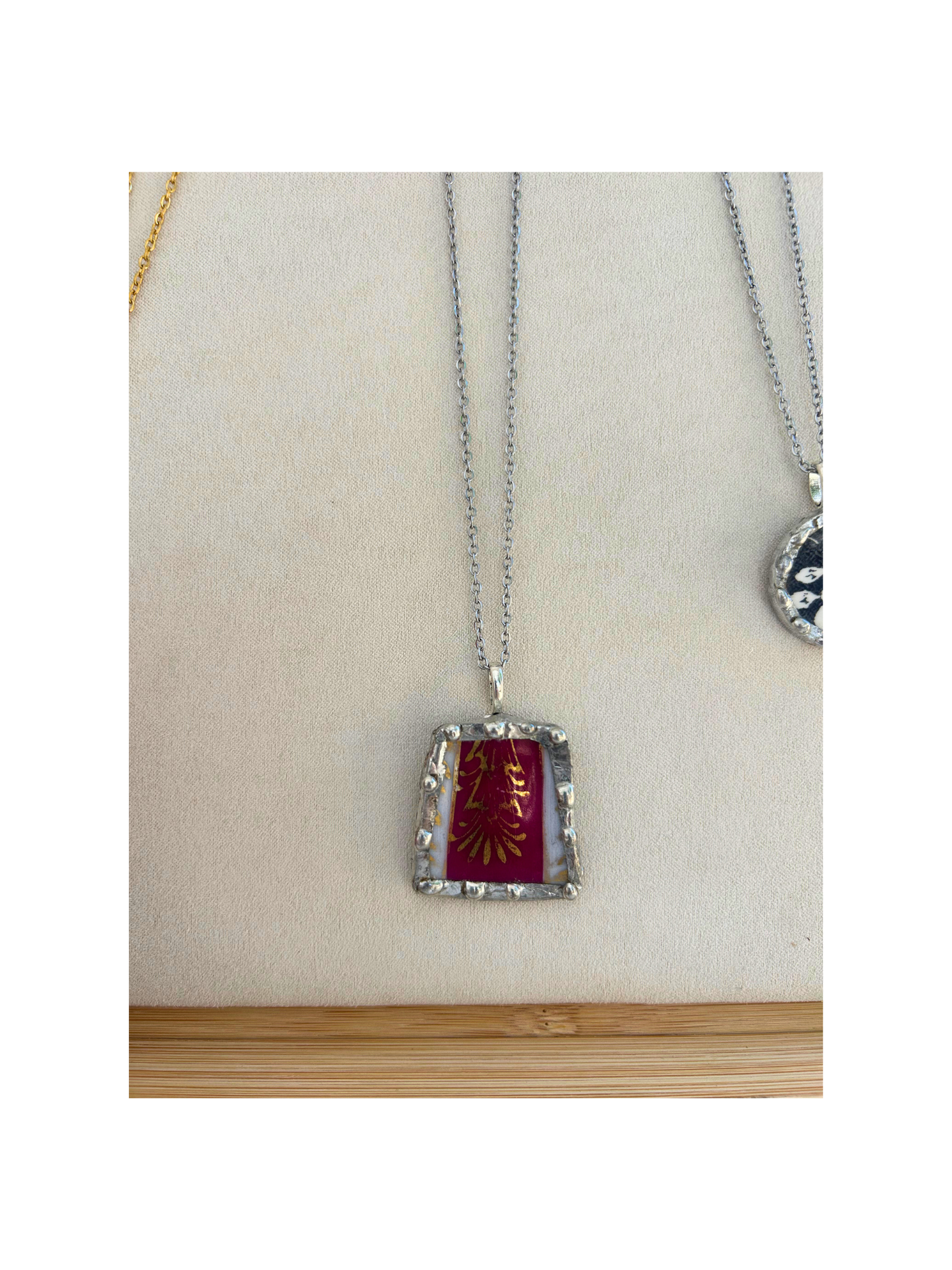 Burgundy gold trim pendant necklace